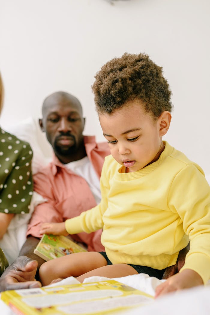 Home A father and child enjoy reading together on the couch, promoting early literacy and bonding.