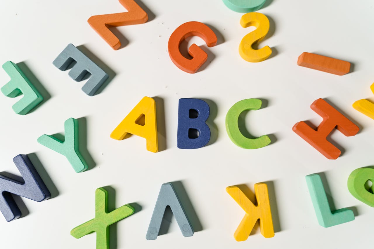 Home Bright, colorful wooden alphabet letters scattered on a surface ideal for childrens learning.